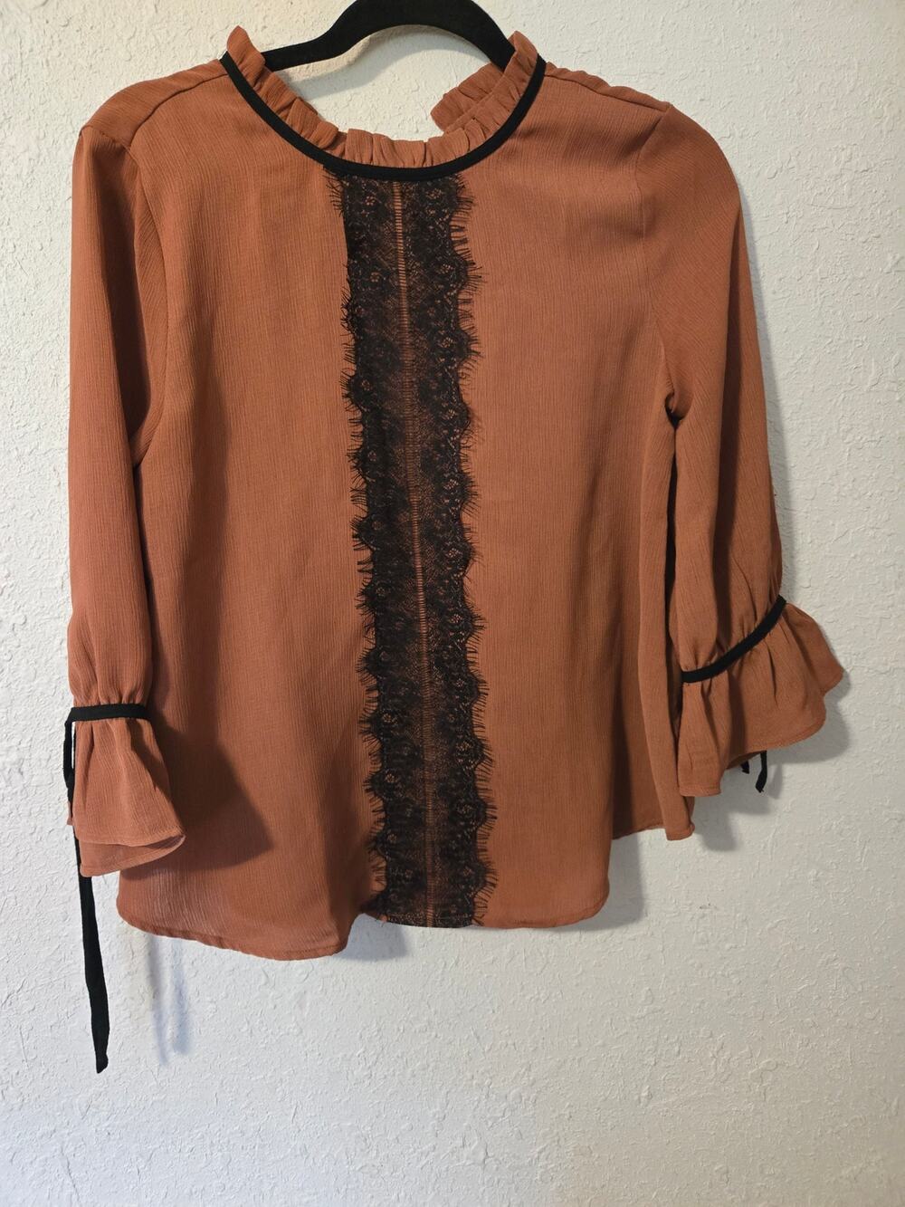 Rust-colored ruffled blouse